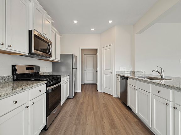 The chef-ready kitchen features granite countertops and stainless-steel appliances.