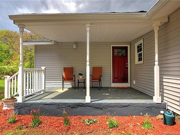 Pretty covered front porch welcomes you!