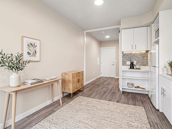 Room for real furniture at the entry, with the kitchen tucked neatly to one side.