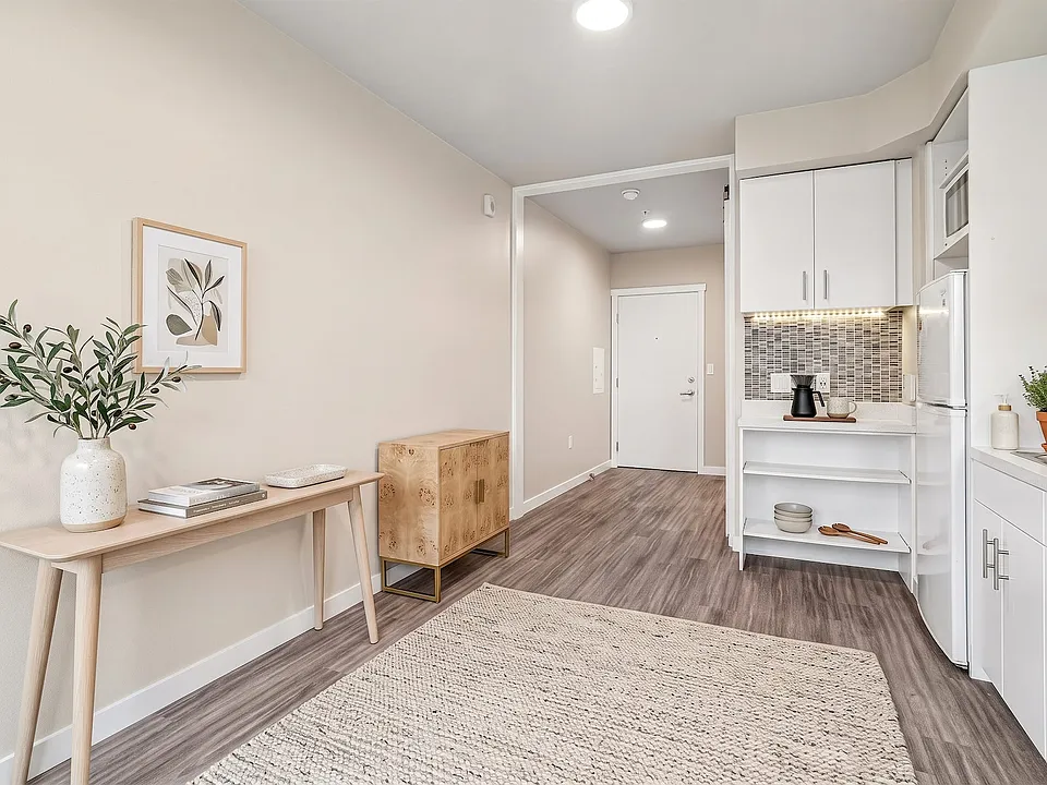 Room for real furniture at the entry, with the kitchen tucked neatly to one side.