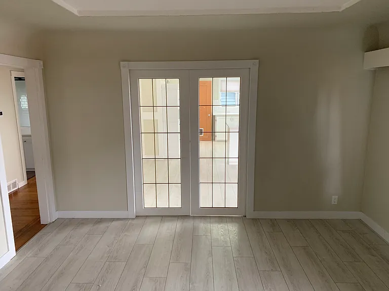 French door between living room and kitchen/dining area