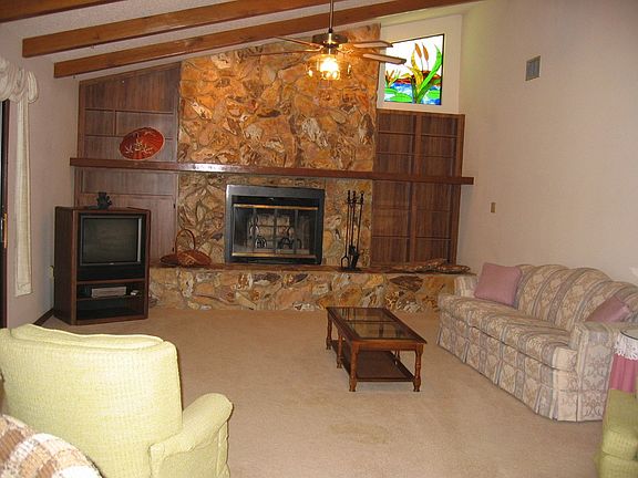 High Beamed Ceilings and Fireplace in Family Room