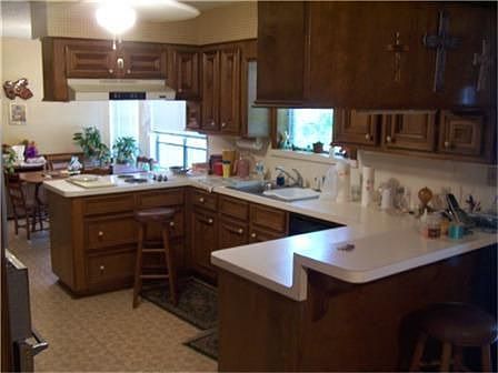 Large kitchen with electric stove cooktop and bar