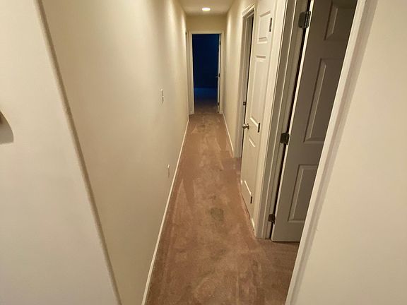 Hallway with 2 bedrooms on right, shared bathroom on left, and master bedroom at end of hallway