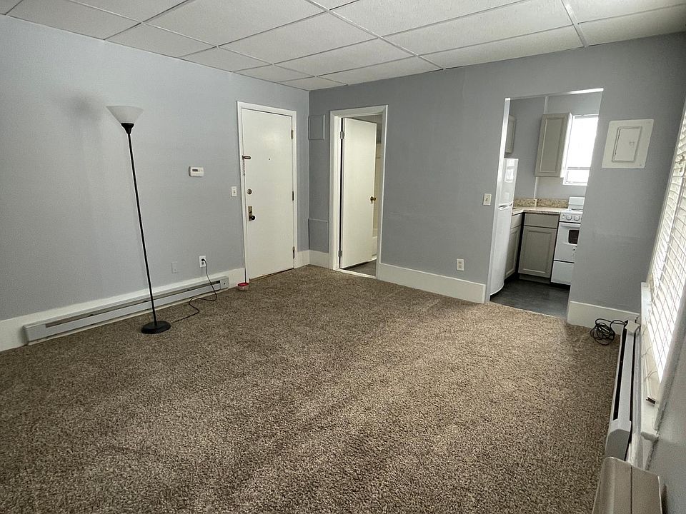 Livingroom looking towards front door, bathroom & kitchen