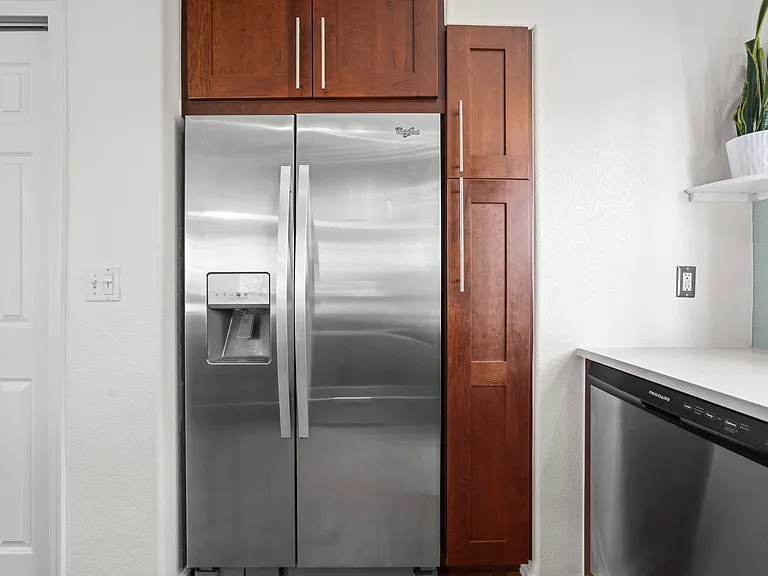 Fridge with ample storage above and pull out vertical pantry door