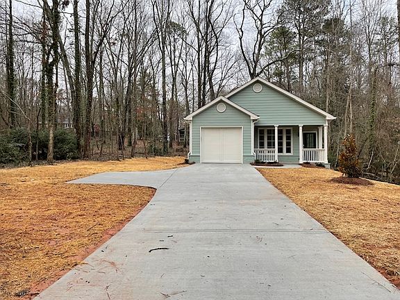Long private driveway from the street. Garage and outside parking. I extended the concrete pad to make it easy to park/turn around.