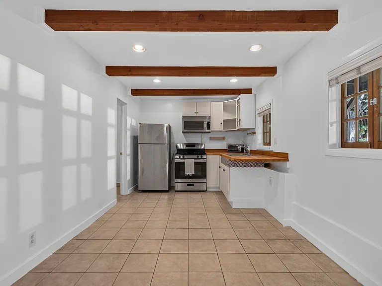 Inside studio (kitchen view) - tile flooring and wood beamed ceiling
