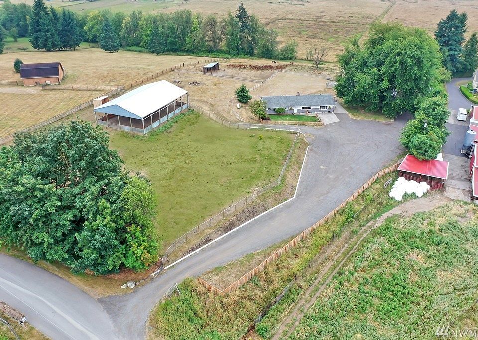 Quintessential small horse farm on 3.64 acres features a 9 stall barn & 50 x 72 covered arena!