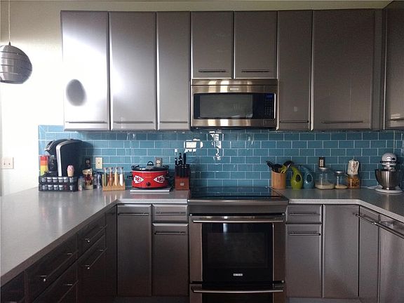 Ultra modern kitchen, and appliances stay.