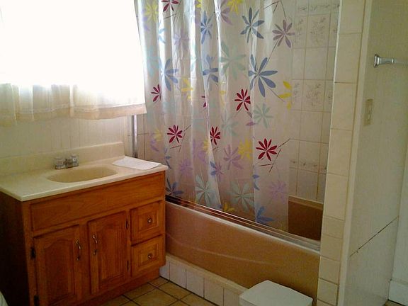 Bathroom includes full tub and bonus storage.