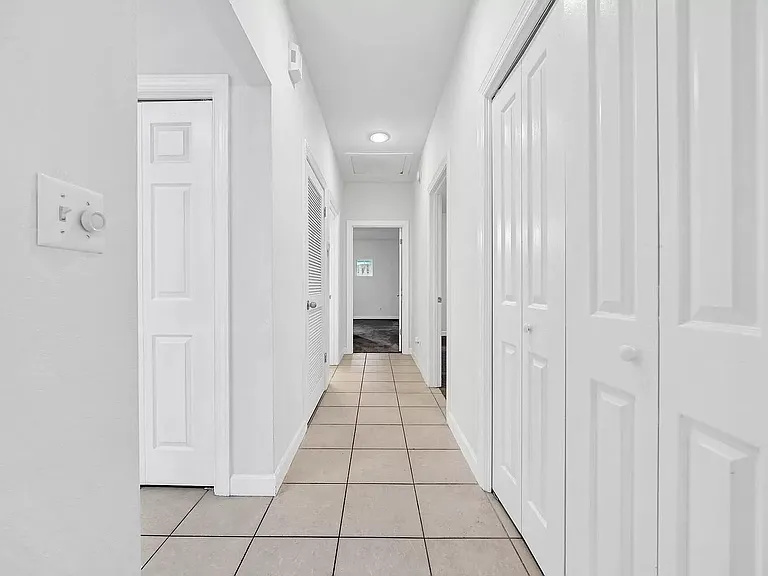 Hallway to bedrooms, W/D to the right behind the doors