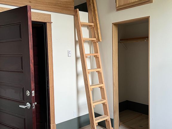 Bedroom, closet and ladder to loft