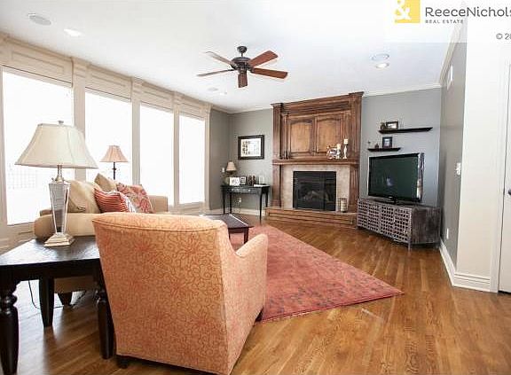 Large family room with tiled fireplace and storage above! Nice n