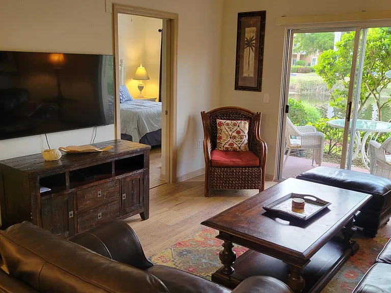 Another beautiful view of the living room and lake through the lanai
