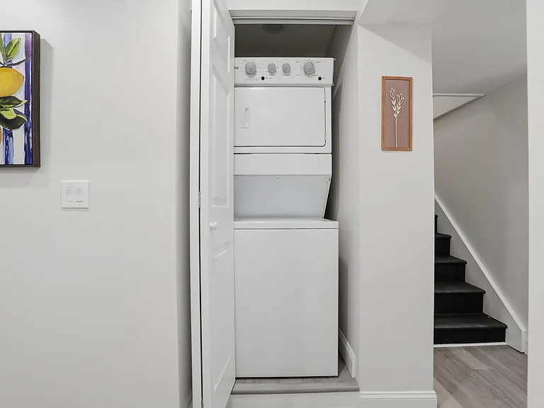 Convenient in-home stacked washer and dryer tucked into a closet off the hallway for easy everyday laundry access.