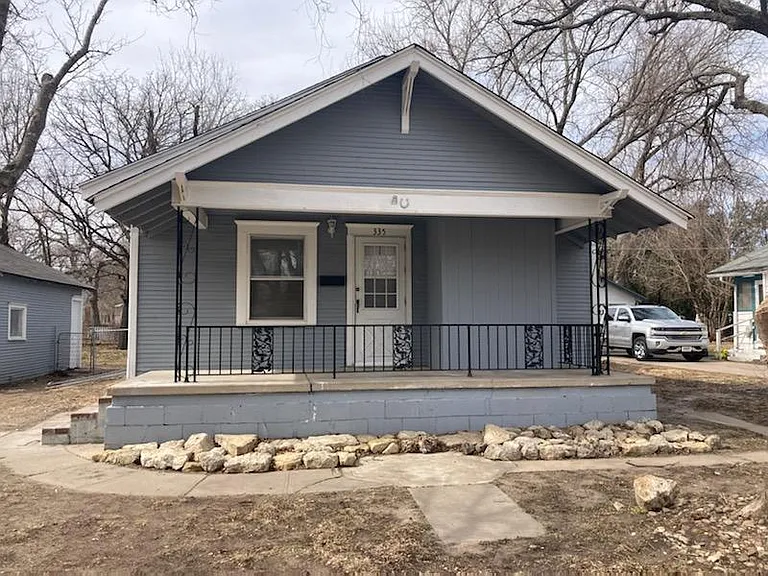 The house is one story with a cellar. Front patio is covered. 2 car garage to the left with electric doors and windows and a side door.