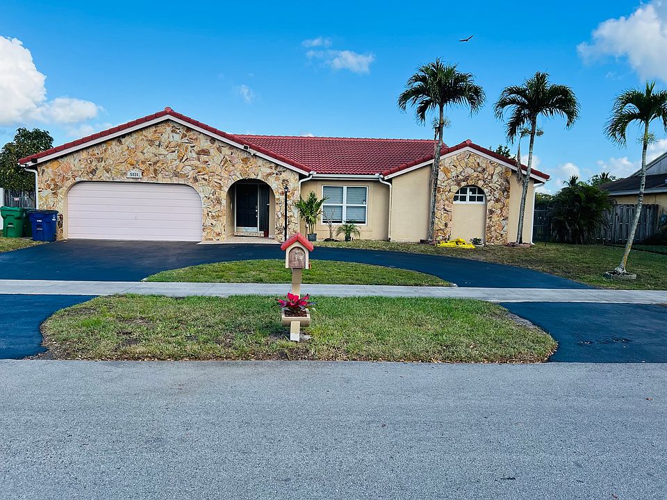 Circular driveway for plenty of parking + 2 car garage; spanish tile roof