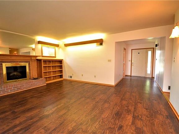Family room with fireplace and built-ins and large mid-century modern entryway