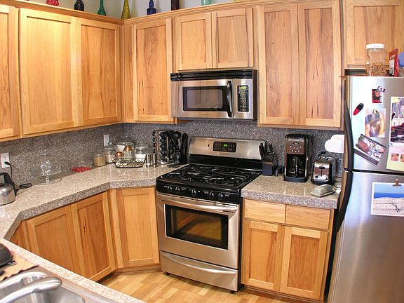 Kitchen with granite, Hickory cabinets, stainless appliances and gas range