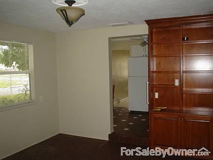 dining room
						:
						built in cabinet to right, floors in dining room and kitchen are brick colored