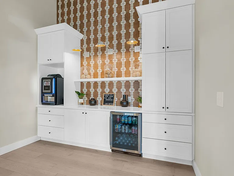 Explore this chic kitchenette designed for ease and style, featuring sleek storage and modern amenities.