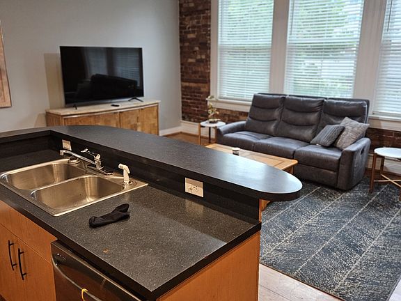 HUGE windows frame the entire wall at the front of the apartment! But plantation blinds give you plenty of privacy when needed!