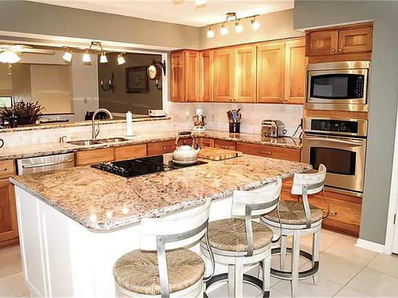 Wow now this is a kitchen! Granite counter tops, updated cabinets, a huge island, breakfast bar, undermount sink, and SS appliances.
