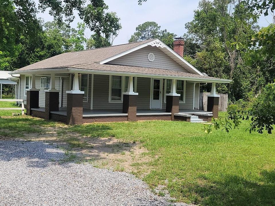 Front view of house with wrap around front porch.