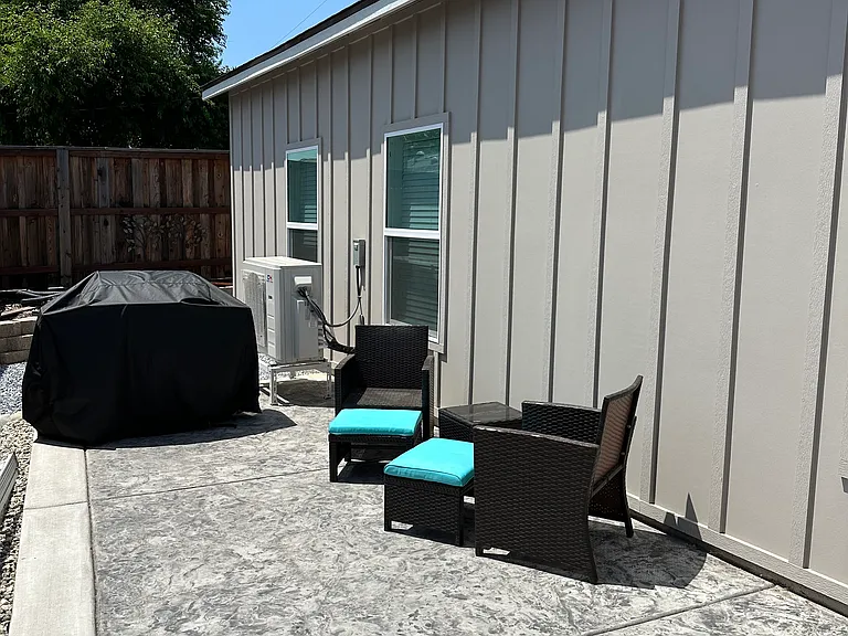 Side yard of property with propane bbq.