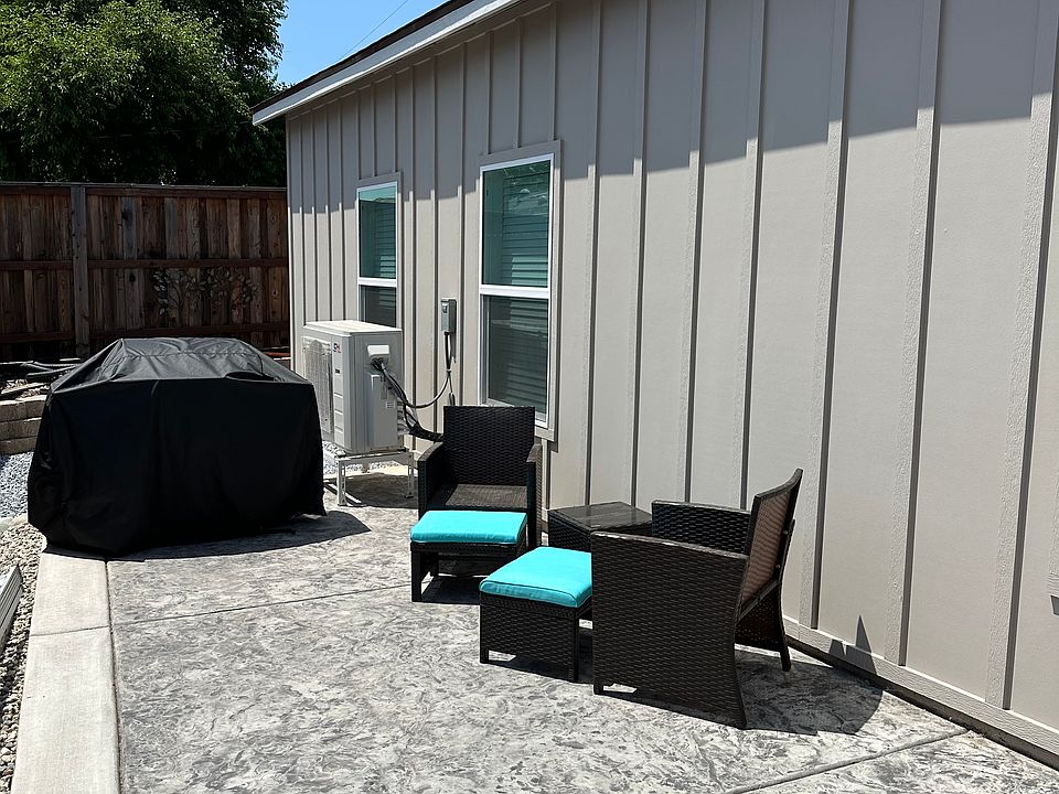 Side yard of property with propane bbq.
