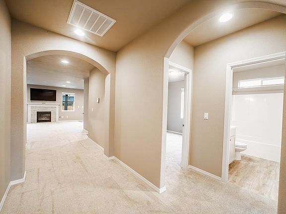 A few steps inside the front door. Guest bath and 2 bedrooms on the right. Living room and fireplace straight ahead.