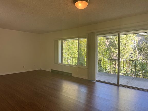 View of living room and large patio from dining area