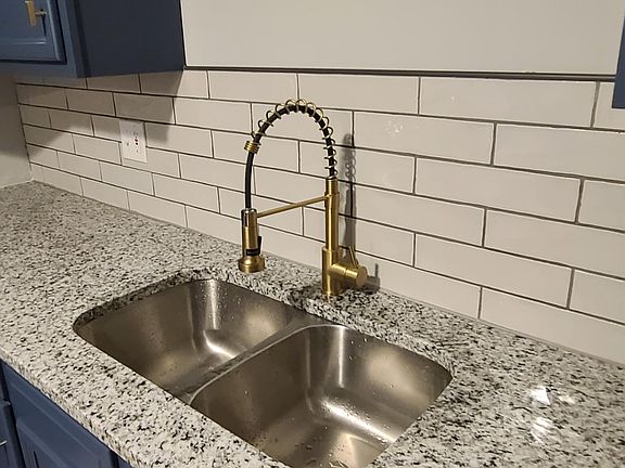 Renovated kitchen - new tile floor, new stainless steel appliances, new granite countertop with tile backsplash