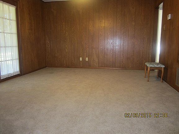 Living room area with doors to covered patio in back.