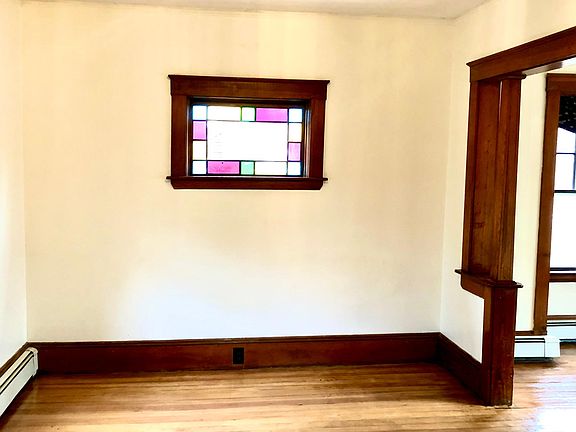 Living room, view from foyer. Original stained glass window