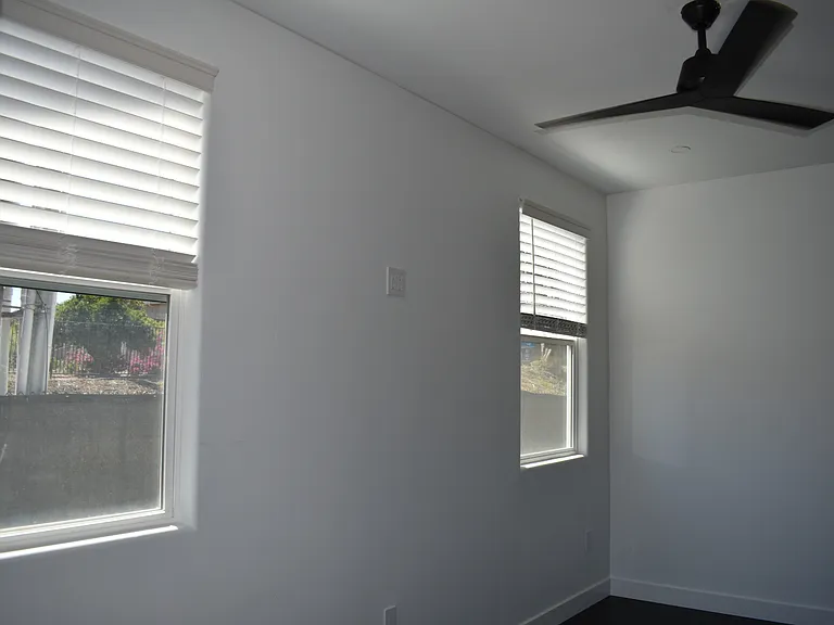 Ceiling fans in both the living room and bedroom.