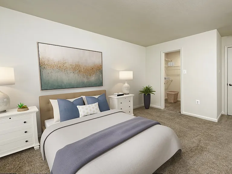 Bedroom with carpeted flooring and walk in closet