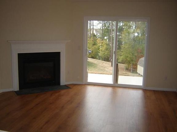 Great room w/ fire place and sliding glass door leading to oversized patio.