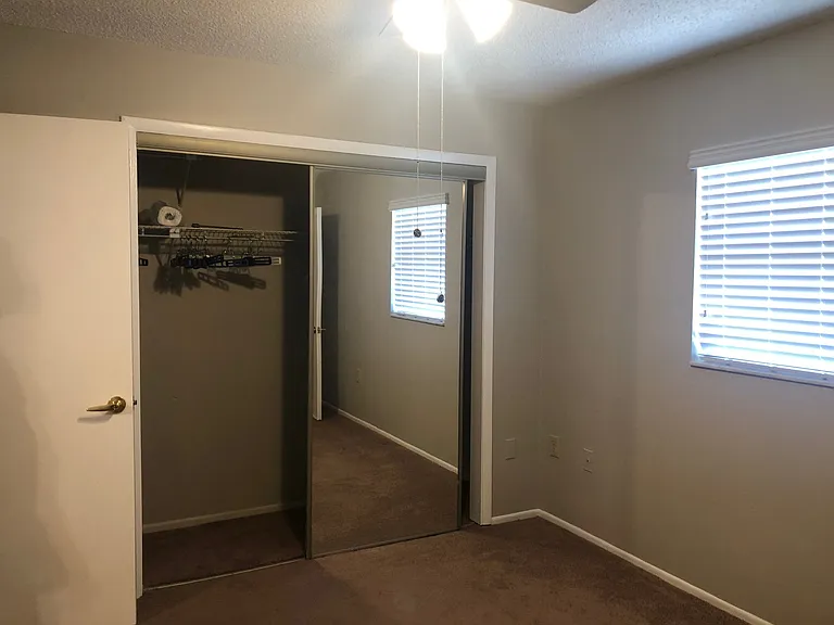 2nd bedroom with mirrored closet doors