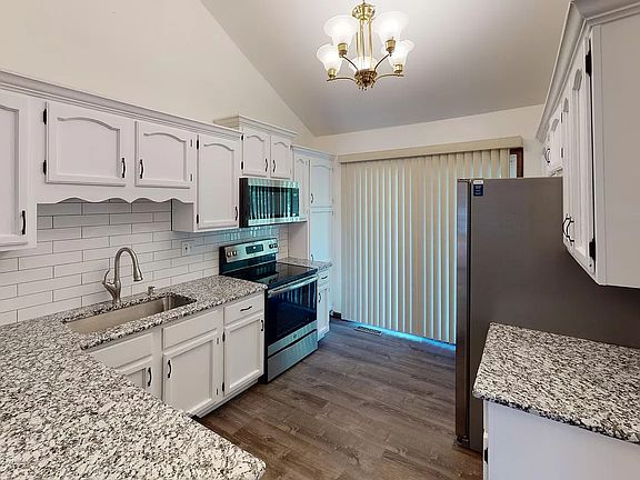 Granite kitchen countertops, stainless steel appliances, and easy access to the backyard.