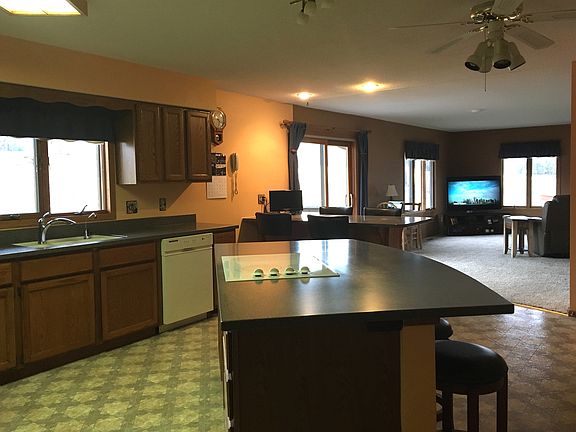 Kitchen flows into TV room.