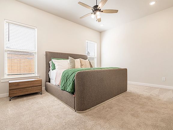Furnished bedroom in the Sienna, one of Betenbough s homes with walk-in closets.