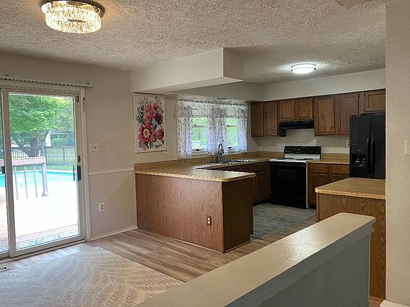 Spacious kitchen and dining area with sliding doors that open to the deck and pool.