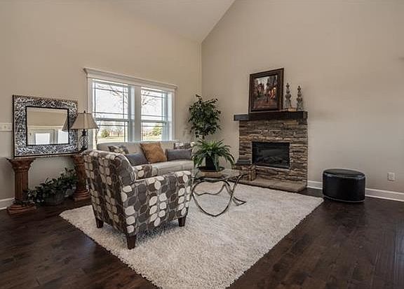 Step into the living room and enjoy the soaring ceilings, hardwood floors and stone fireplace.