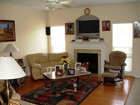 Hardwoods In The Living Room & Charming Gas Log Fireplace.