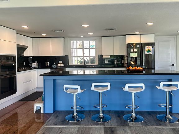 Spacious kitchen with a touchscreen range hood and water filtration system