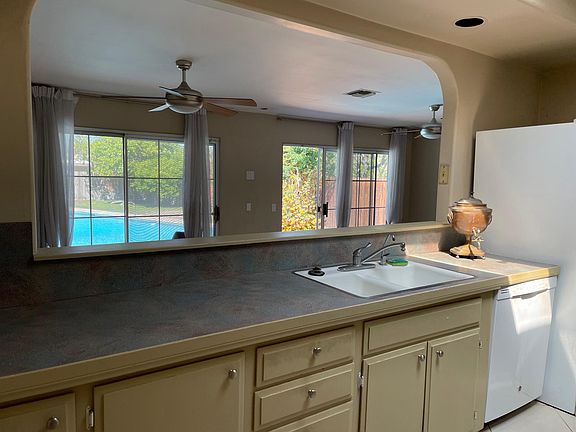 Kitchen is open to the family room below and backyard