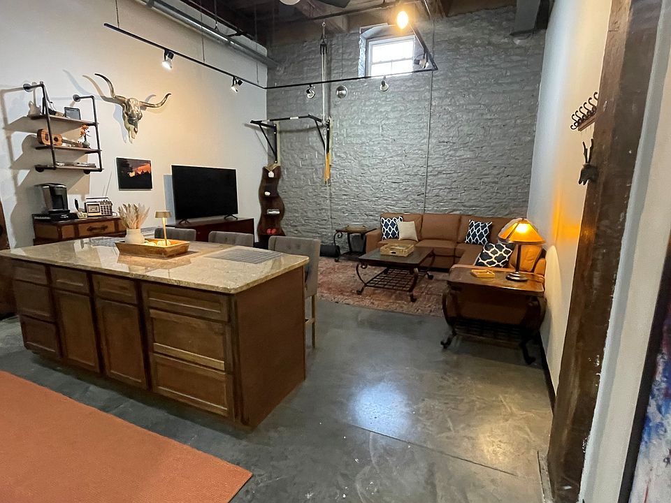 living, kitchen and gym area