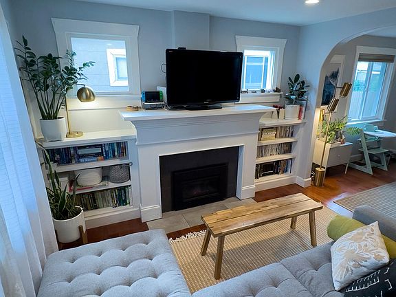Living room with gas fireplace and built-in bookshelves.